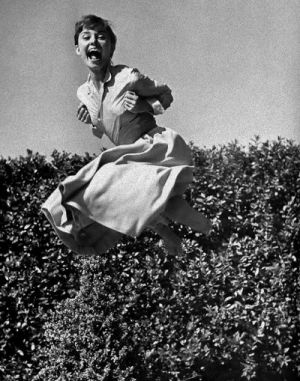 Audrey Hepburn laughing and jumping photo - mylusciouslife.com.jpg
